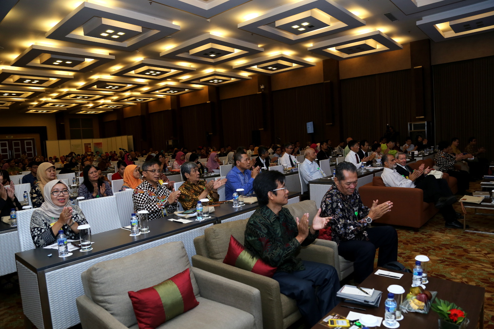 Participants and speakers applaud during opening ceremony